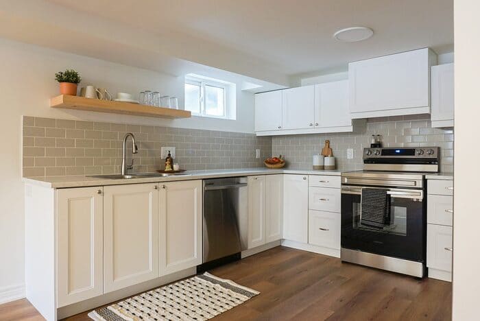 Niagara basement renovation white kitchen and open wood shelving