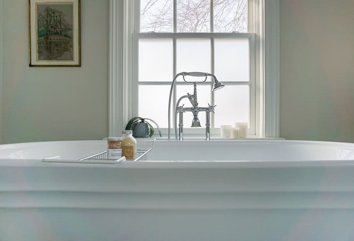 Niagara bathroom renovation with white bathtub and chrome faucet