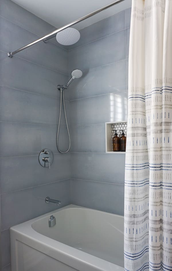 Niagara bathroom renovation with blue tiled shower and chrome fixtures