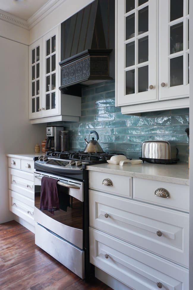 Niagara kitchen renovation with white cabinets, blue backsplash, and white quartz counters