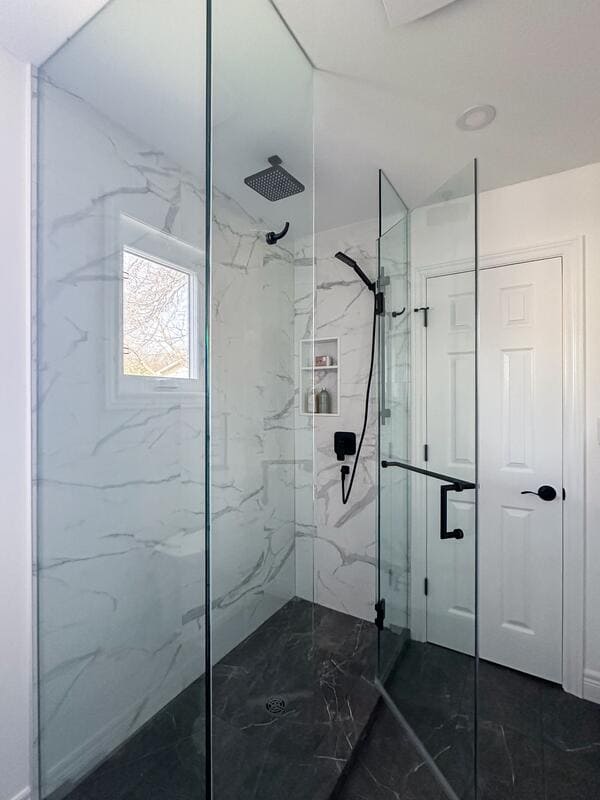 Fonthill bathroom renovation glass shower with white marble wall tile and black flooring tile